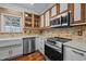 Updated kitchen with white cabinets, stone countertops, stainless steel appliances for modern comfort at 3738 Lindsey Woods Rd, Hillsborough, NC 27278