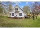 Side view of the home highlighting the deck, windows, and landscaping at 3738 Lindsey Woods Rd, Hillsborough, NC 27278