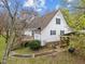 View of the backyard of the home with deck, staircase and lush landscaping at 3738 Lindsey Woods Rd, Hillsborough, NC 27278