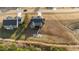 Aerial view of backyard featuring stone patio, firepit, and sidewalk leading to a wooden back porch at 40 Cinnamon Teal Way, Youngsville, NC 27596