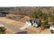 Aerial view of a beautifully landscaped property featuring a well-maintained lawn, pond, and mature trees at 40 Cinnamon Teal Way, Youngsville, NC 27596