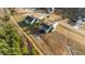 An aerial view of a gray home with an outdoor firepit and unkempt, expansive backyard at 40 Cinnamon Teal Way, Youngsville, NC 27596