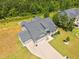 Aerial view of the home highlighting its roof, landscaping, and three-car garage at 40 Cinnamon Teal Way, Youngsville, NC 27596