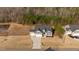 Aerial view of a beautifully landscaped property featuring a well-maintained lawn, pond, and mature trees at 40 Cinnamon Teal Way, Youngsville, NC 27596