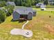 Aerial view showcases the house, yard, fire pit, and neighborhood, highlighting the property's setting and layout at 40 Cinnamon Teal Way, Youngsville, NC 27596