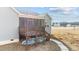 Back deck with a screened-in porch, wooden railings, and steps leading down to the yard, with a blue kayak stowed underneath at 40 Cinnamon Teal Way, Youngsville, NC 27596