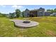 Spacious backyard with a custom patio and stone fire pit, offering an inviting outdoor space at 40 Cinnamon Teal Way, Youngsville, NC 27596