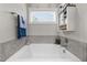 Relaxing soaking tub in a bathroom with a window view and stylish decor at 40 Cinnamon Teal Way, Youngsville, NC 27596