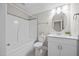Clean and bright bathroom featuring a shower-tub combo, modern vanity, and a neutrally painted wall at 40 Cinnamon Teal Way, Youngsville, NC 27596