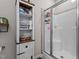 Modern bathroom featuring a tiled shower and ample shelving for storage at 40 Cinnamon Teal Way, Youngsville, NC 27596