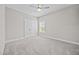 An airy carpeted bedroom shows closet space, a window, and a ceiling fan at 40 Cinnamon Teal Way, Youngsville, NC 27596