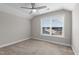 Bright bedroom featuring neutral carpet, a ceiling fan, and a view of the neighborhood at 40 Cinnamon Teal Way, Youngsville, NC 27596