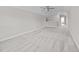 Spacious carpeted bonus room with a landing that leads to a hallway providing ample space for relaxation and entertainment at 40 Cinnamon Teal Way, Youngsville, NC 27596