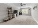 Bright bonus room featuring neutral carpet, entertainment center, and a ceiling fan at 40 Cinnamon Teal Way, Youngsville, NC 27596