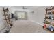 Spacious bonus room with neutral carpet, ceiling fan, and ladder shelves at 40 Cinnamon Teal Way, Youngsville, NC 27596