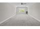 Bright bonus room with neutral walls, plush carpeting, a ceiling fan, and a window with natural light at 40 Cinnamon Teal Way, Youngsville, NC 27596
