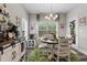Charming breakfast nook with a round table and chairs, bathed in natural light from the windows at 40 Cinnamon Teal Way, Youngsville, NC 27596