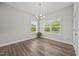 Bright dining area featuring wood floors, natural light, and elegant chandelier at 40 Cinnamon Teal Way, Youngsville, NC 27596