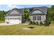 Charming home with well-manicured lawn, three-car garage, and inviting curb appeal at 40 Cinnamon Teal Way, Youngsville, NC 27596