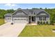 Charming home featuring a three-car garage and professionally landscaped front yard at 40 Cinnamon Teal Way, Youngsville, NC 27596
