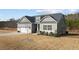 Charming front exterior showcasing a well-manicured lawn and landscaping, garage, and classic architectural design at 40 Cinnamon Teal Way, Youngsville, NC 27596
