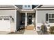 Charming front porch with gray siding, brick steps, and welcoming decor at 40 Cinnamon Teal Way, Youngsville, NC 27596