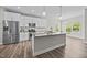 Well-appointed kitchen with stainless steel appliances, granite counters, and white cabinets at 40 Cinnamon Teal Way, Youngsville, NC 27596