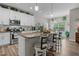 Gourmet kitchen features a large center island, granite countertops, and modern appliances, perfect for cooking at 40 Cinnamon Teal Way, Youngsville, NC 27596