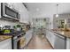 The galley kitchen features granite counters and ample storage and views of the breakfast nook and backyard at 40 Cinnamon Teal Way, Youngsville, NC 27596