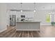 Modern kitchen featuring stainless steel appliances, granite countertops, and a center island at 40 Cinnamon Teal Way, Youngsville, NC 27596