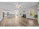 Spacious open-concept living room with hardwood floors, a fireplace, and abundant natural light at 40 Cinnamon Teal Way, Youngsville, NC 27596