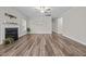 Spacious living room featuring a fireplace, ceiling fan, and stylish, modern wood-look flooring at 40 Cinnamon Teal Way, Youngsville, NC 27596