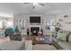 Cozy living room with a fireplace, plush seating, and natural light creating a warm, inviting atmosphere at 40 Cinnamon Teal Way, Youngsville, NC 27596