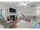 Comfortable living room featuring a fireplace, ceiling fan and lots of natural light at 40 Cinnamon Teal Way, Youngsville, NC 27596