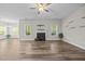Bright and airy living room featuring a fireplace, hardwood floors, and a ceiling fan at 40 Cinnamon Teal Way, Youngsville, NC 27596