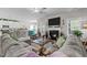 Open-concept living room flowing into the kitchen area offering a seamless space for entertaining and relaxation at 40 Cinnamon Teal Way, Youngsville, NC 27596