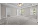 A bright main bedroom is enhanced with a tray ceiling, a ceiling fan and carpeted floor at 40 Cinnamon Teal Way, Youngsville, NC 27596