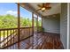 Inviting screened porch with wood flooring, ceiling fan, and open views of the surrounding natural landscape at 40 Cinnamon Teal Way, Youngsville, NC 27596