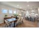 An open concept dining room and kitchen featuring an island, pendant lighting, and natural light at 40 Eagle Crest Ct # Clayton Low Country, Lillington, NC 27546