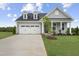 Charming single-Gathering house with light gray siding, a well-manicured lawn, and a tree-lined front yard at 40 Eagle Crest Ct # Clayton Low Country, Lillington, NC 27546