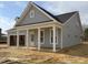A light gray single-Gathering home with white columns on the covered front porch and an attached garage at 40 Eagle Crest Ct # Clayton Low Country, Lillington, NC 27546