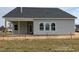 The rear view of a light gray single-Gathering house with a covered patio and fenced-in yard at 40 Eagle Crest Ct # Clayton Low Country, Lillington, NC 27546