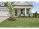 A well-manicured lawn and a tree-lined front yard of single-Gathering home with light gray siding at 40 Eagle Crest Ct # Clayton Low Country, Lillington, NC 27546