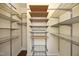 Walk-in closet with metal and wooden shelving and vinyl flooring at 407 Misty Grove Cir, Morrisville, NC 27560