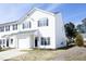 Charming two-story townhouse with white siding, black shutters, and an attached one car garage at 407 Misty Grove Cir, Morrisville, NC 27560