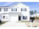 Charming two-story townhouse featuring a front-entry garage, neat landscaping, and a classic black front door at 407 Misty Grove Cir, Morrisville, NC 27560