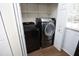 Laundry room featuring a modern black washer and dryer and wire shelves at 407 Misty Grove Cir, Morrisville, NC 27560