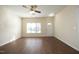 Bright living room with hard wood floors, a ceiling fan, and a large window, great for relaxing at 407 Misty Grove Cir, Morrisville, NC 27560