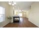 Open concept living room features a fireplace, wood floors, white walls, and natural light at 407 Misty Grove Cir, Morrisville, NC 27560