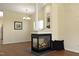 Inviting living room featuring a fireplace, built in shelving, and hardwood flooring at 407 Misty Grove Cir, Morrisville, NC 27560